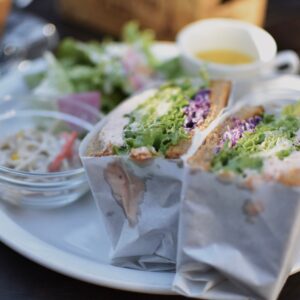 Close-up of a wrapped sandwich with fresh salad, showcasing vibrant colors and appetizing presentation.